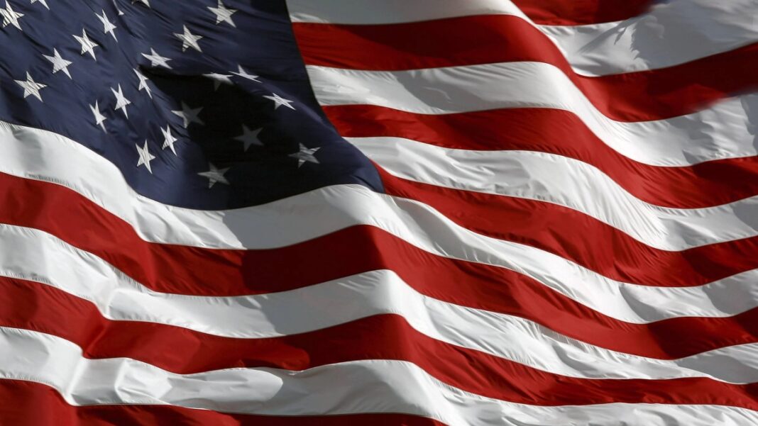 National Debt: Memorial Day and the Debt We Ignore Flying American Flag